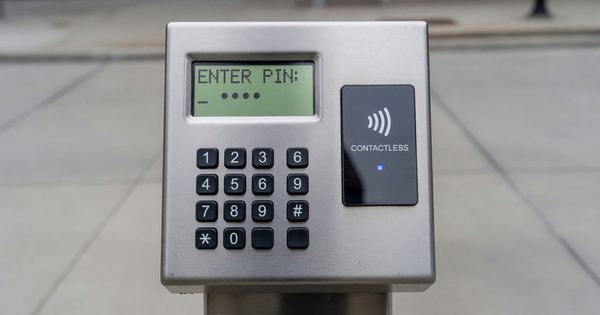 Parking pay station keypad displaying a PIN entry prompt next to a contactless reader